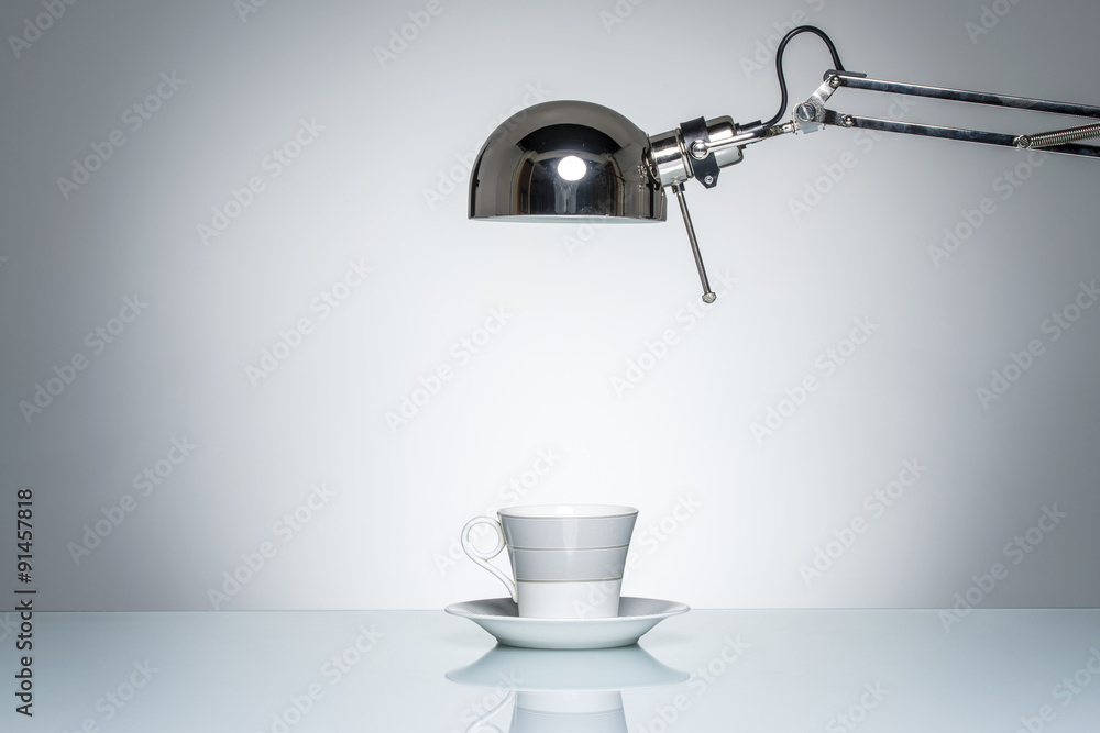 lighting up white mug coffee cup with desk lamp lighting up white mug coffee cup with desk lamp