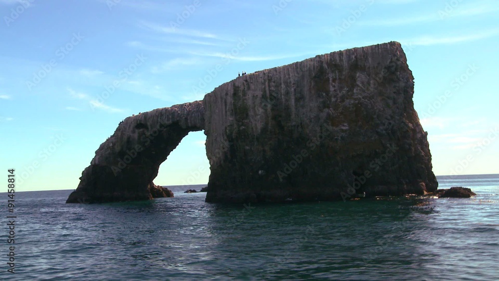 Anacapa Island's iconic natural bridge and nearby islets in Channel Islands National Park as seen from a passing boat. Anacapa Island's iconic natural bridge and nearby islets in Channel Islands National Park as seen from a passing boat.