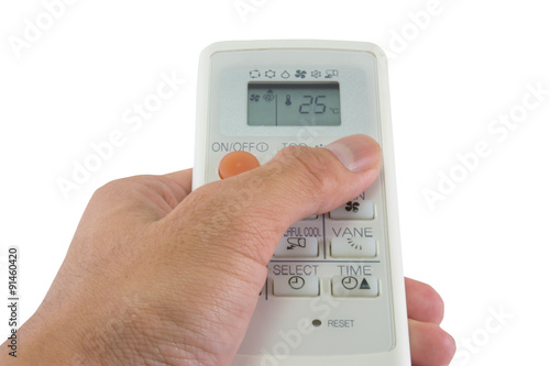 Air conditioner remote control in hand. with isolated white back