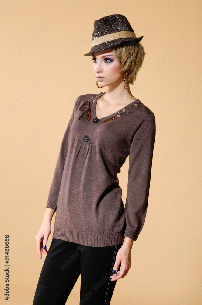Portrait of young beautiful girl in a hat posing on beige background Portrait of young beautiful girl in a hat posing on beige background