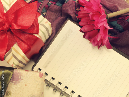 blank notebook and flowersstill life retro filter background photo