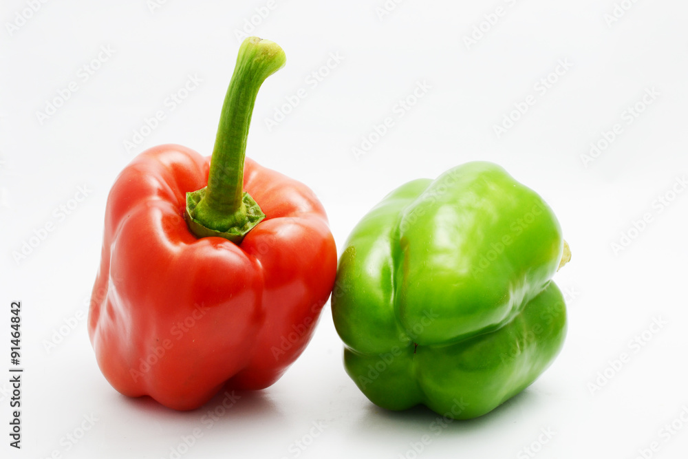 red and green bell pepper on white background red and green bell pepper on white background