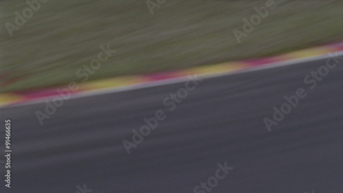 A formula car drives on a circuit track. photo