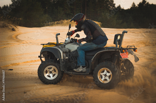 Racing ATV is sand.