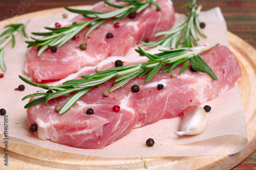 fresh raw meat with rosemary and pepper