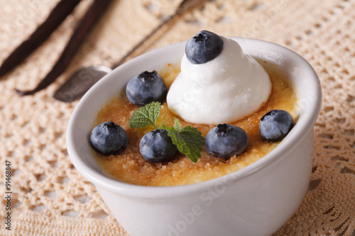 French vanilla cream caramel dessert with blueberries close-up 