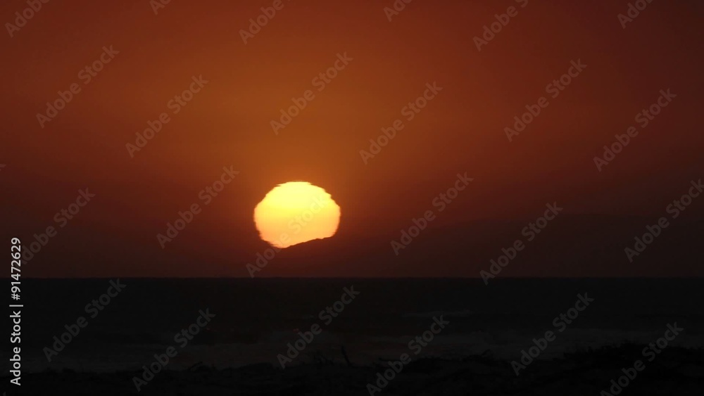 Close-up time lapse of sun setting over the Pacific Ocean in Ventura, California. Close-up time lapse of sun setting over the Pacific Ocean in Ventura, California.