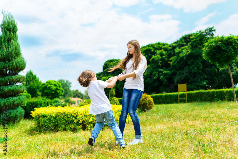 Happy smiling girl and boy playing on grass. Happy smiling girl and boy playing on grass.