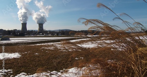 Smoke rises from the nuclear power plant at Three Mile Island, Pennsylvania with farm fields foreground. photo