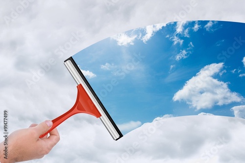 Fototapeta Naklejka Na Ścianę i Meble -  Composite image of hand using wiper