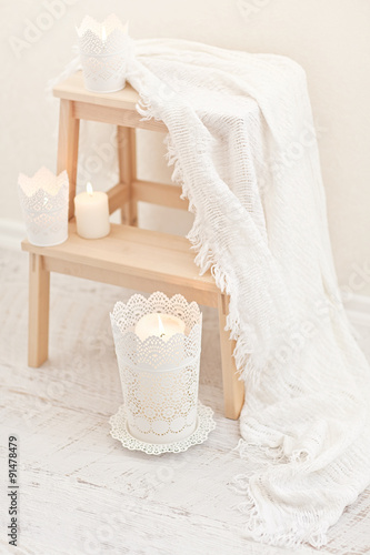 Natural small wooden ladder on white wood floor with white pleid photo