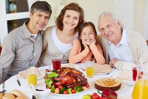 Family by dinner table