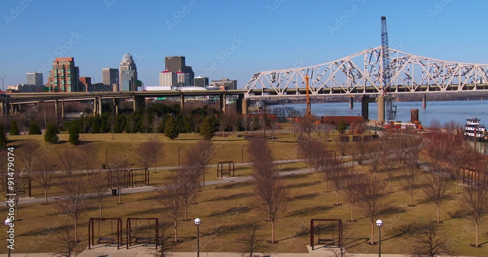 The skyline of Louisville, Kentucky behind bridges over the Ohio River. The skyline of Louisville, Kentucky behind bridges over the Ohio River.