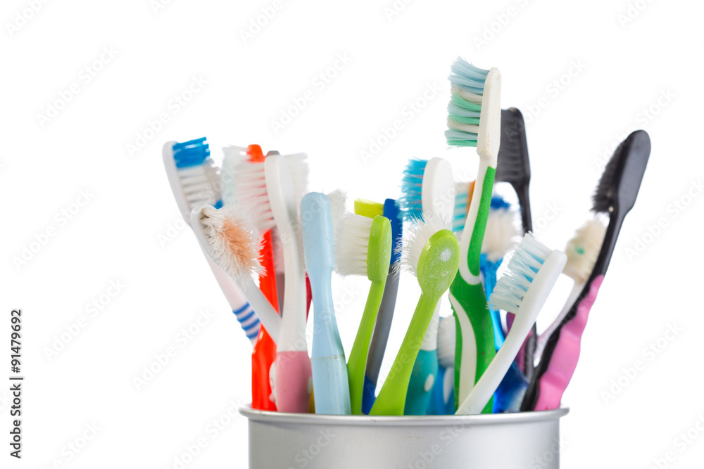 Group of old and used toothbrush in metal cup Group of old and used toothbrush in metal cup