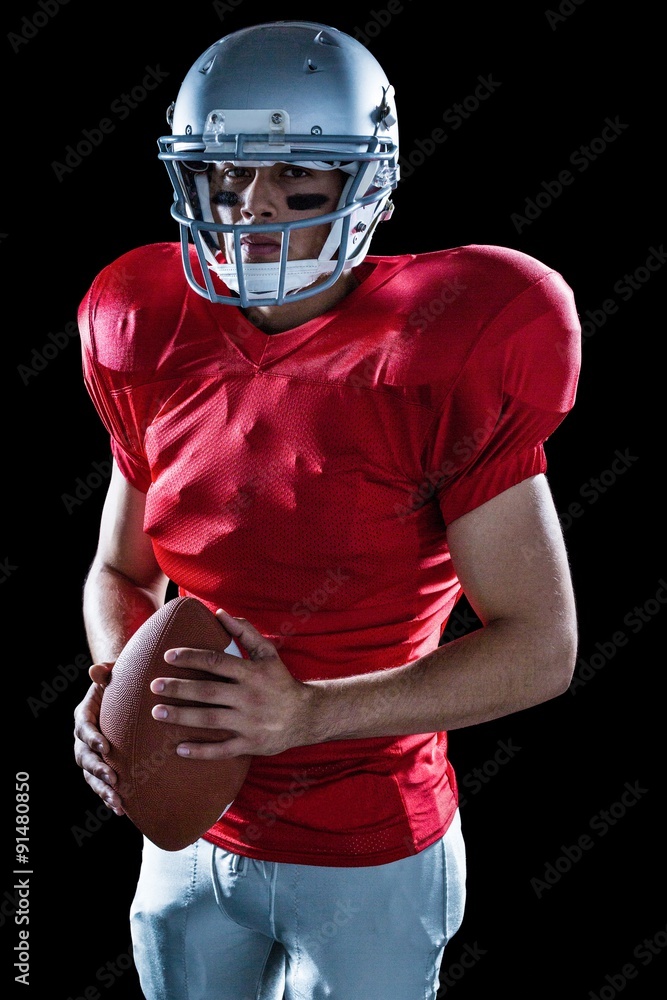 Portrait of determined sportsman with American football