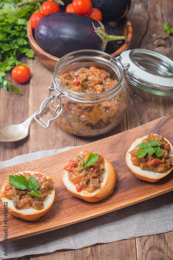 Eggplant caviar in a glass jar with croutons