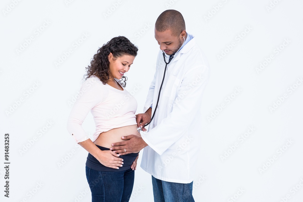 Smiling doctor examining pregnant woman Smiling doctor examining pregnant woman