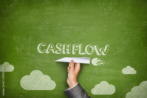 Cash flow concept on blackboard with paper plane