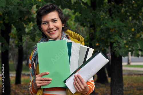 Woman gathering old journals to recycle photo