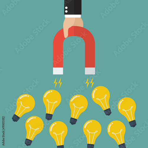 Businessman holding magnet attracting lightbulbs idea