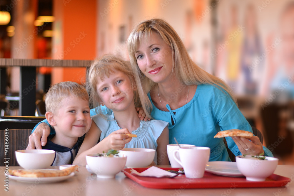 The young woman and two children in cafe
The young woman and two children in cafe