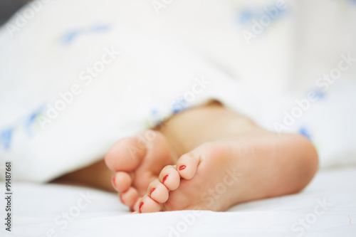 Feet of sleeping woman © Arman Zhenikeyev