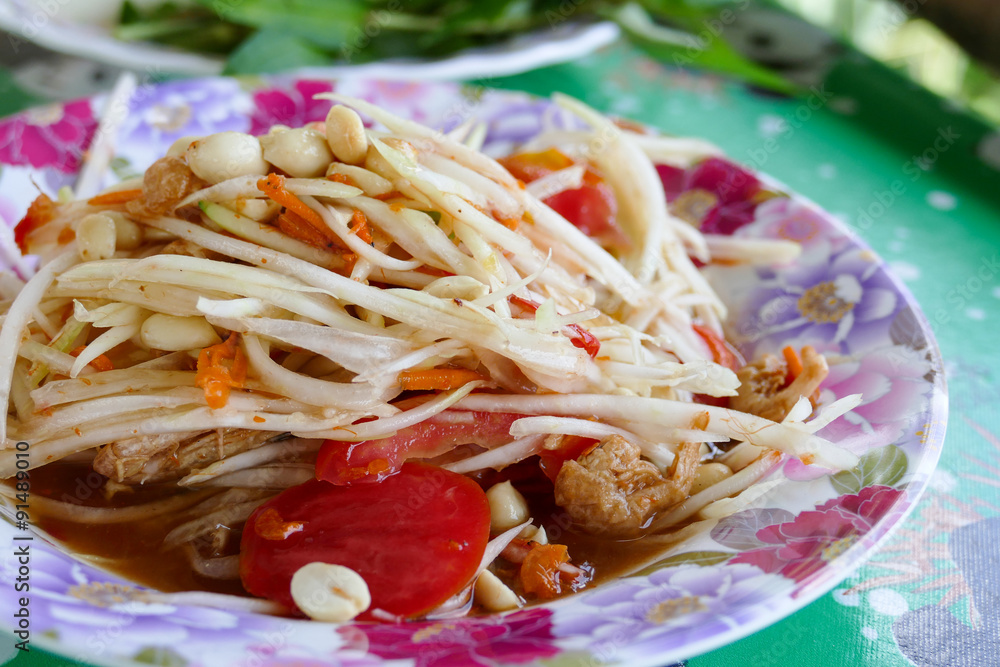 spicy papaya salad on colorful plate spicy papaya salad on colorful plate