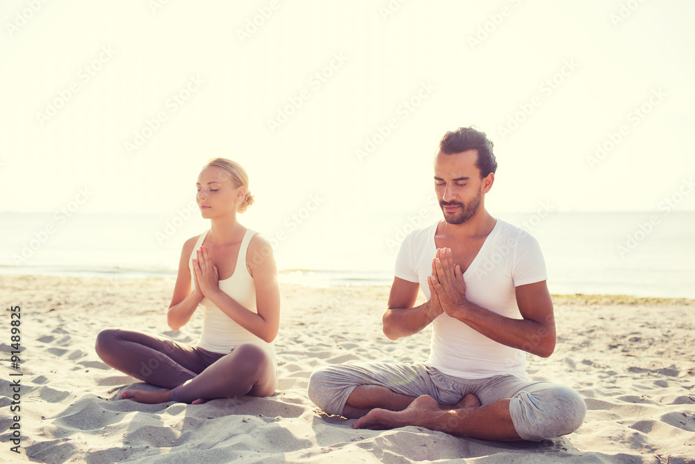 smiling couple making yoga exercises outdoors smiling couple making yoga exercises outdoors