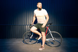 man posing with bicycle