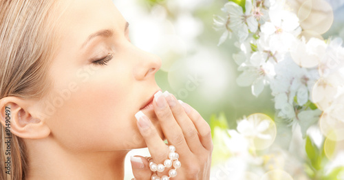 beautiful woman with pearl over cherry blossom
