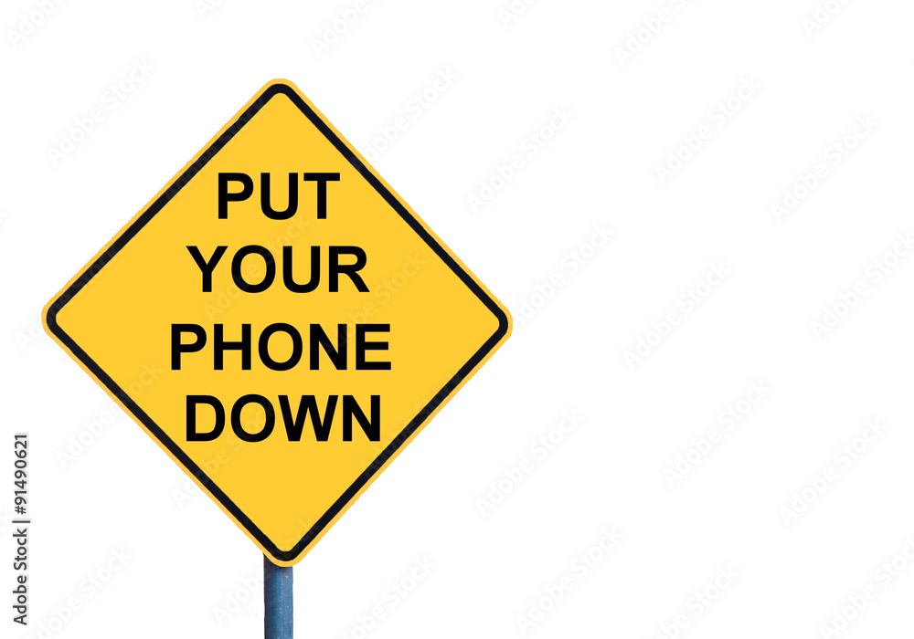 Yellow roadsign with PUT YOUR PHONE DOWN message