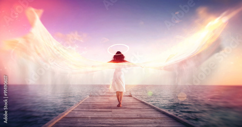 Bilde på lerret Female angel on a jetty overlooking the ocean