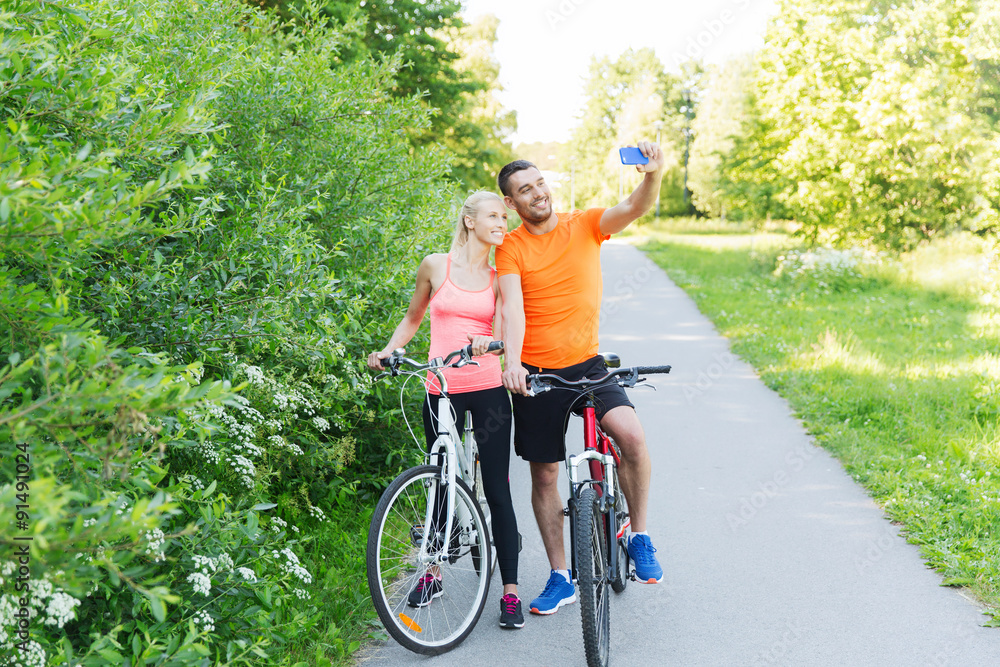 Naklejka premium couple with bicycle and smartphone taking selfie