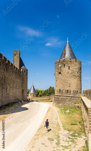 Carcassonne, France. The road to the site of the moat between the inner (left) and external (right) ring of fortifications. Fortress of Carcassonne is included in the UNESCO World Heritage List