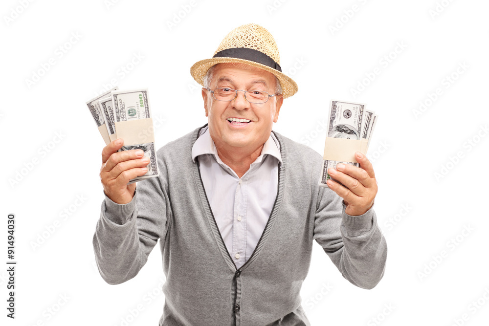 Overjoyed senior holding two stacks of money Overjoyed senior holding two stacks of money