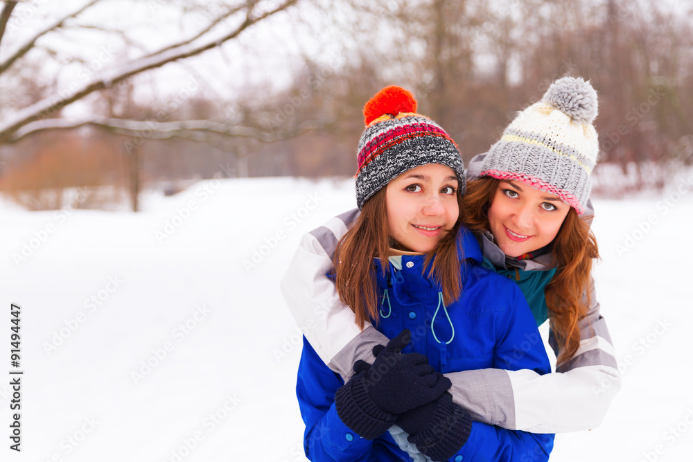 Fototapeta premium Two Winter women have fun outdoors