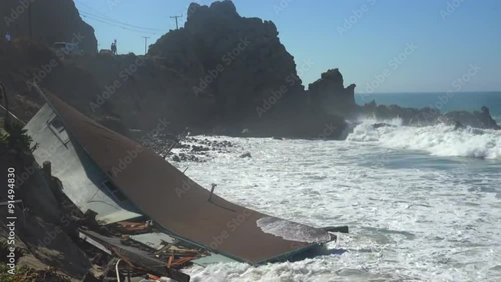 A house along the Malibu coastline collapses into the sea after a major storm surge.