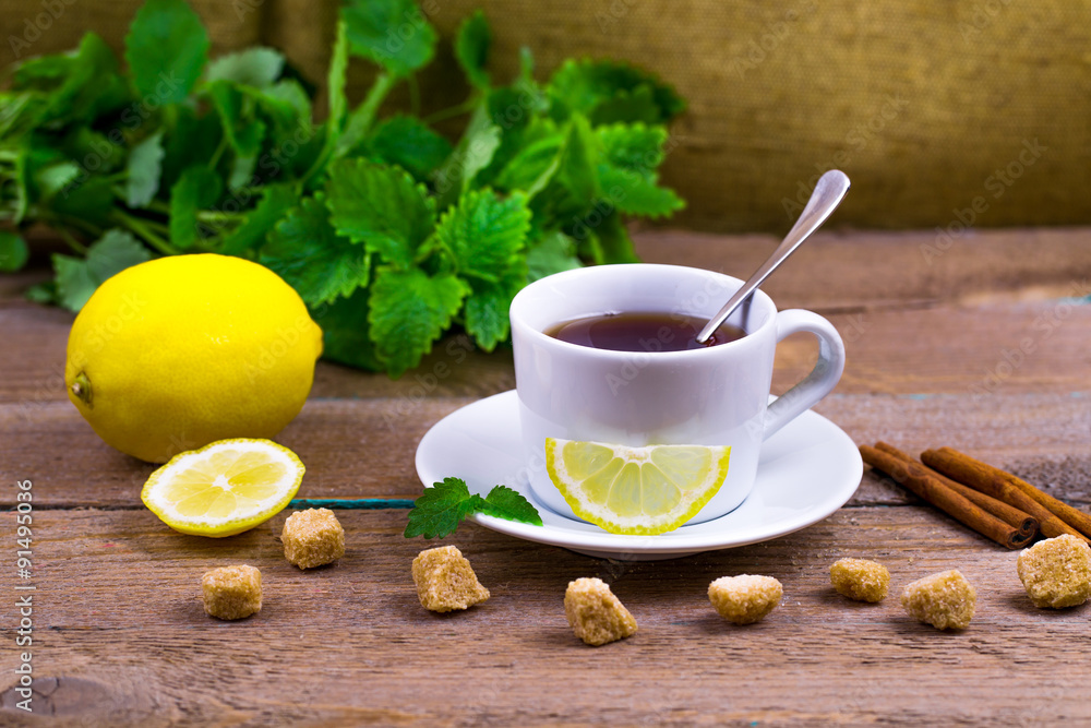 Tea with a lemon, a lime, cinnamon, a melissa and cane sugar Tea with a lemon, a lime, cinnamon, a melissa and cane sugar