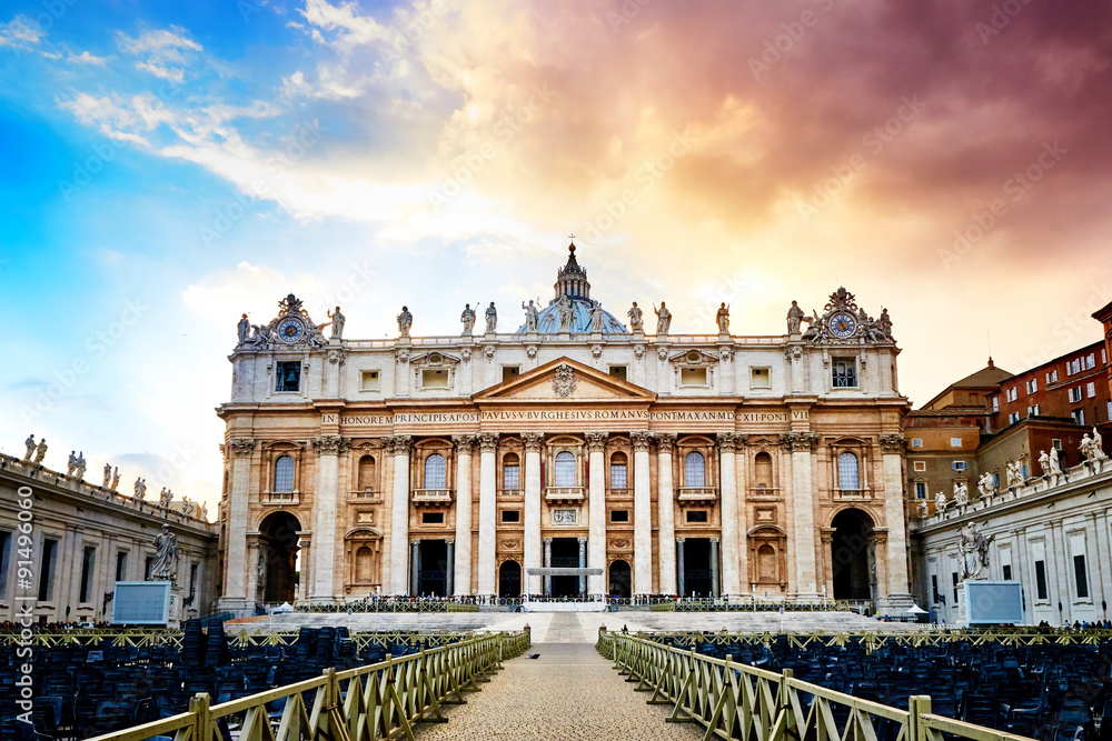 Dramatic sunset over facade of the basilica of St. Peter's