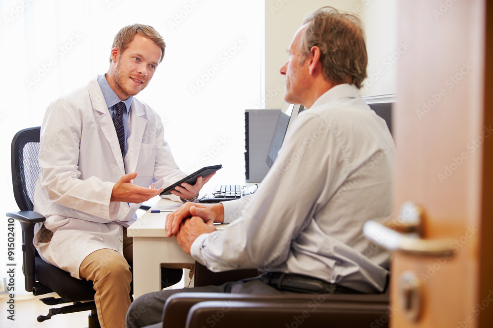 Male Patient Having Consultation With Doctor In Office Male Patient Having Consultation With Doctor In Office