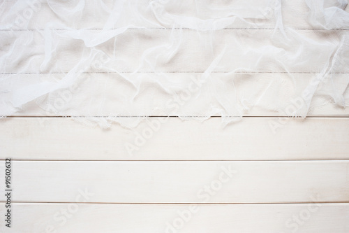 White wooden background with cheesecloth photo