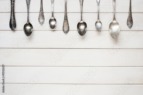 Silver spoons on the white table