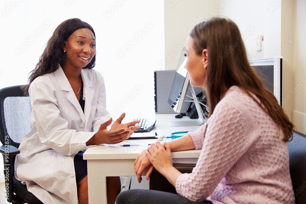 Patient Having Consultation With Female Doctor In Office Patient Having Consultation With Female Doctor In Office