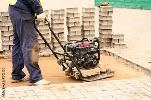 tamping sand for paving laying photo