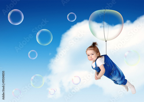Funny kid fly on soap bubble, flight creative concept © dimj