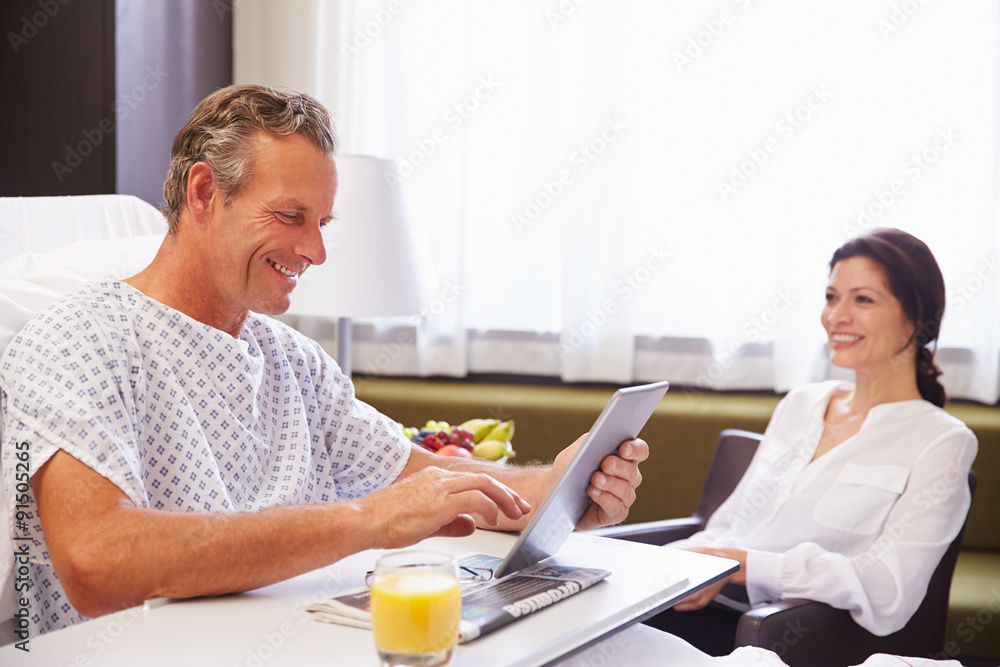 Male Patient In Hospital Bed Using Digital Tablet Male Patient In Hospital Bed Using Digital Tablet