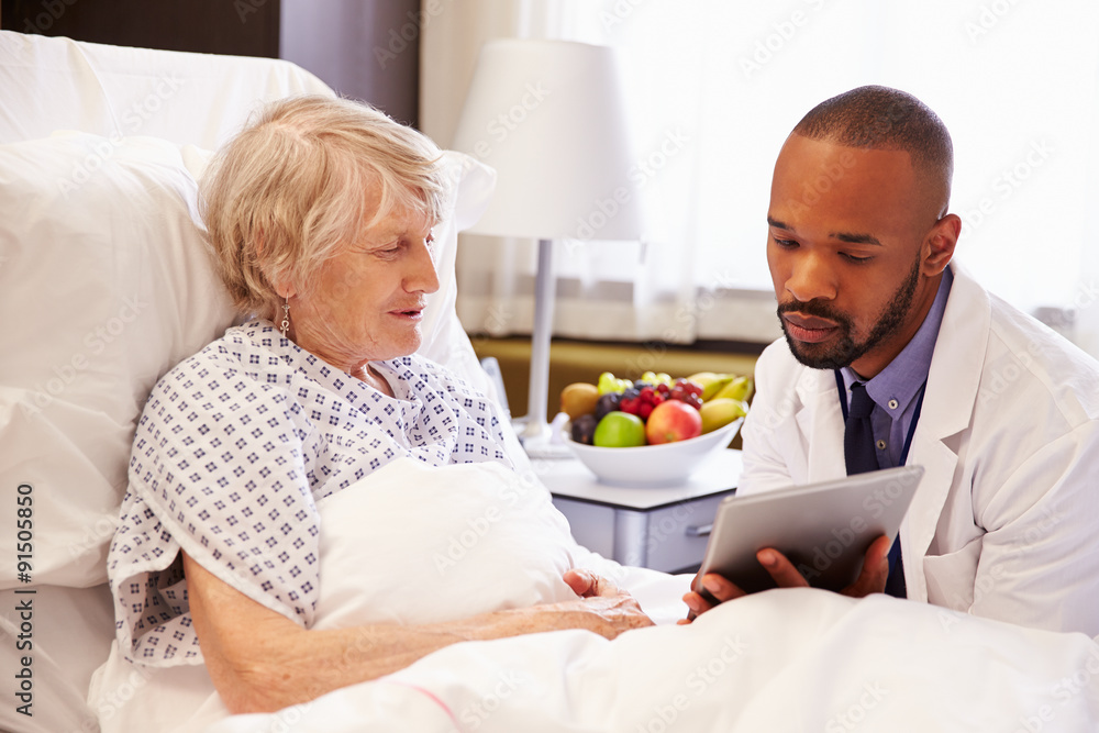 Doctor Talking To Senior Female Patient In Hospital Bed Doctor Talking To Senior Female Patient In Hospital Bed