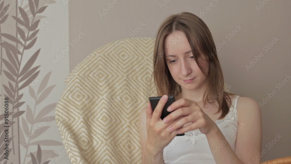 Young beautiful woman sitting with smart phone. Young beautiful woman sitting with smart phone.