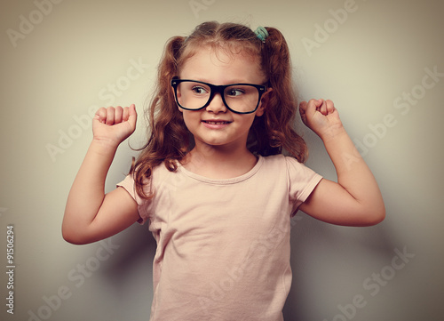 Strong happy successful girl showing muscular. Healthy child lif