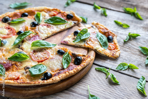 Photos Cut pizza on the wooden board